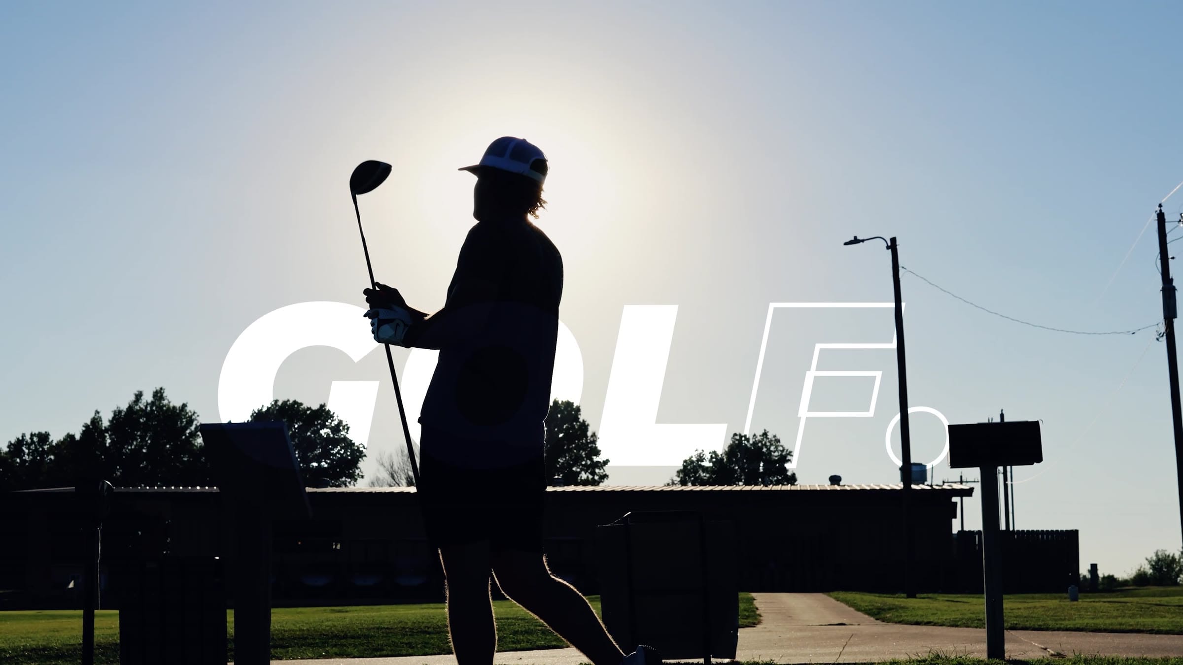 A golfer in silhouette against the sun at Crawford Hills